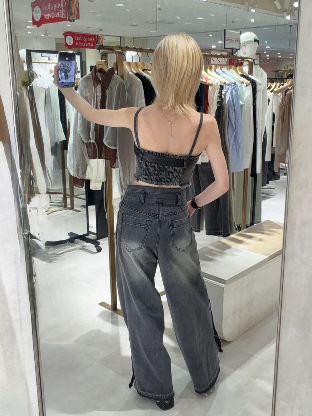 ブラック系のその他トップス、ブラック系のデニムパンツ、ブラック系のブーツを着用したレディースの春コーディネートの2枚目の写真