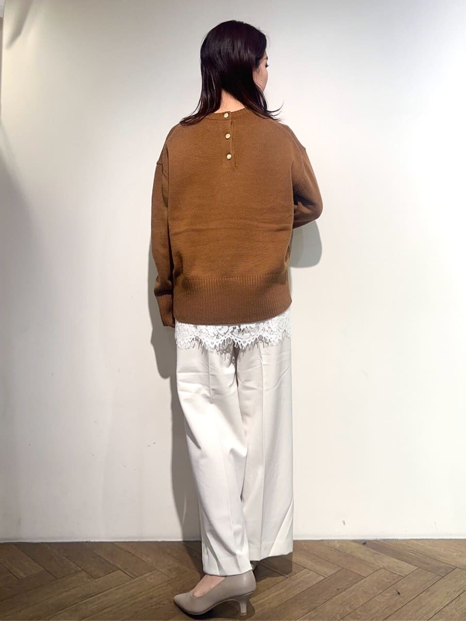 ホワイト系のダウンジャケット/コート、イエロー系のニット/セーター、ホワイト系のTシャツ/カットソーを着用したレディースの冬コーディネートの8枚目の写真