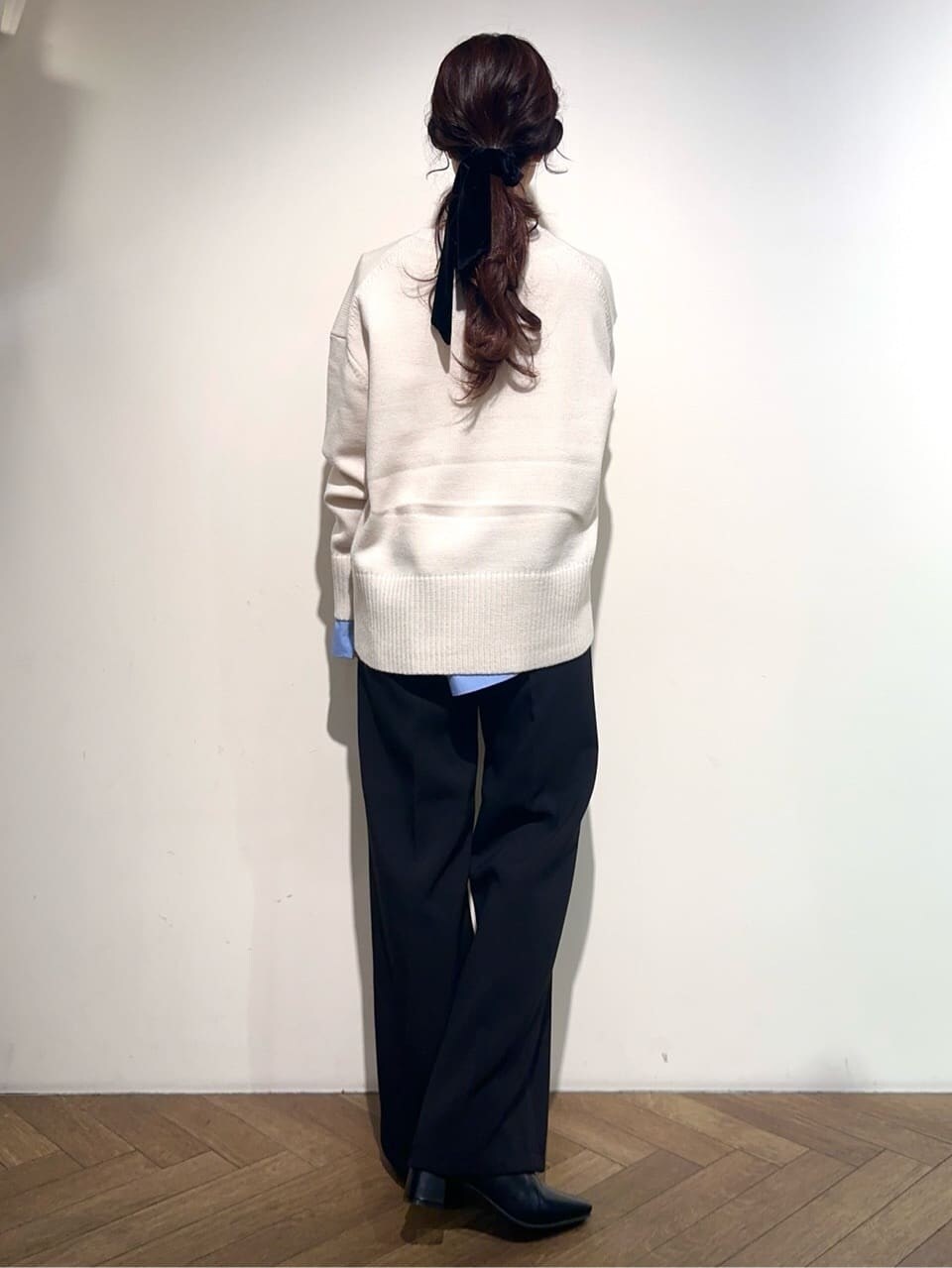 ホワイト系のニット/セーター、ブルー系のTシャツ/カットソー、ブラック系のその他パンツを着用したレディースの冬コーディネートの3枚目の写真