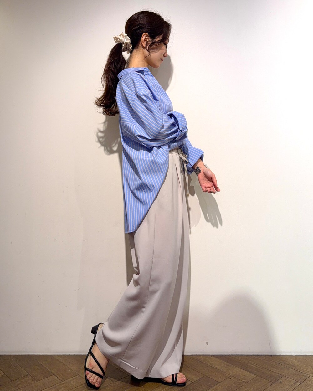 ブルー系のシャツ/ブラウス、ベージュ系のその他パンツ、ブラック系のサンダルを着用したレディースの春コーディネートの5枚目の写真