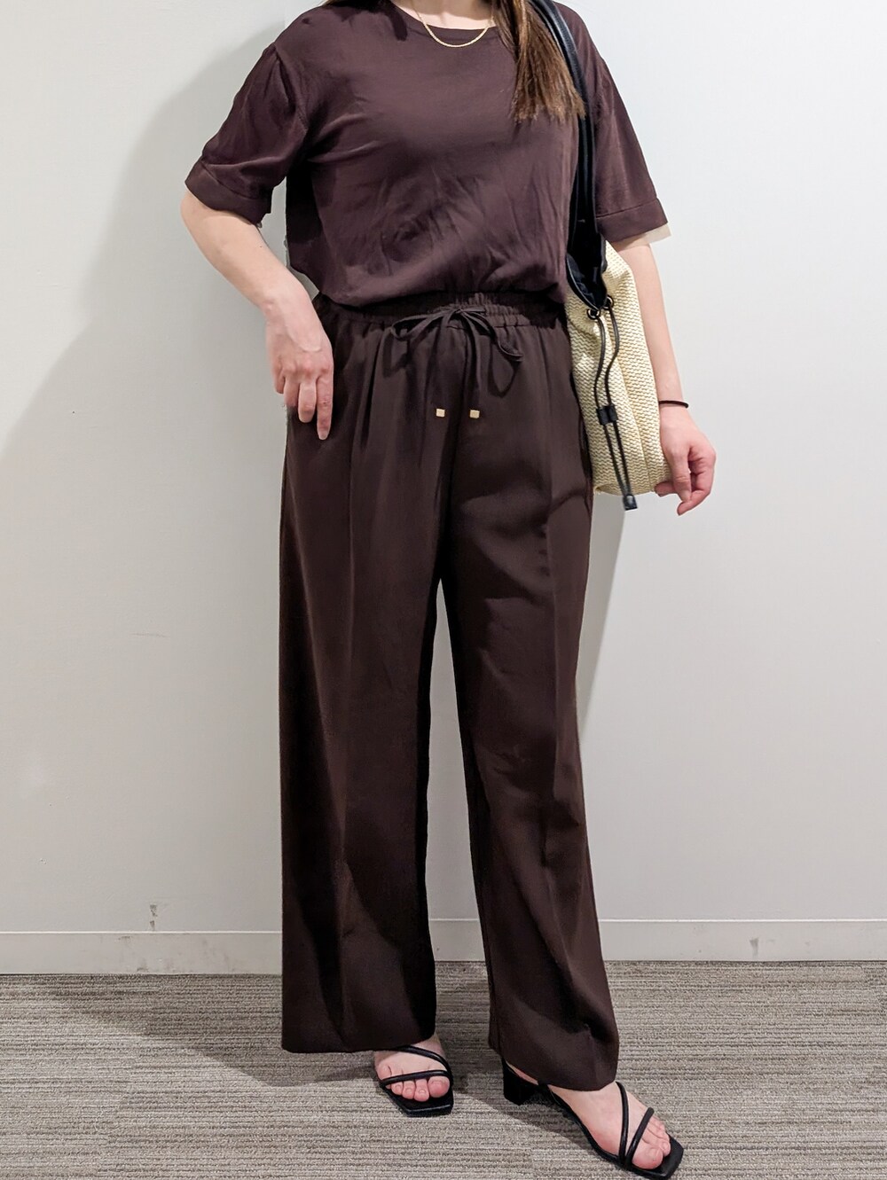 ブラウン系のニット/セーター、ブラウン系のその他パンツ、ホワイト系のトートバッグを着用したレディースの夏コーディネートの8枚目の写真