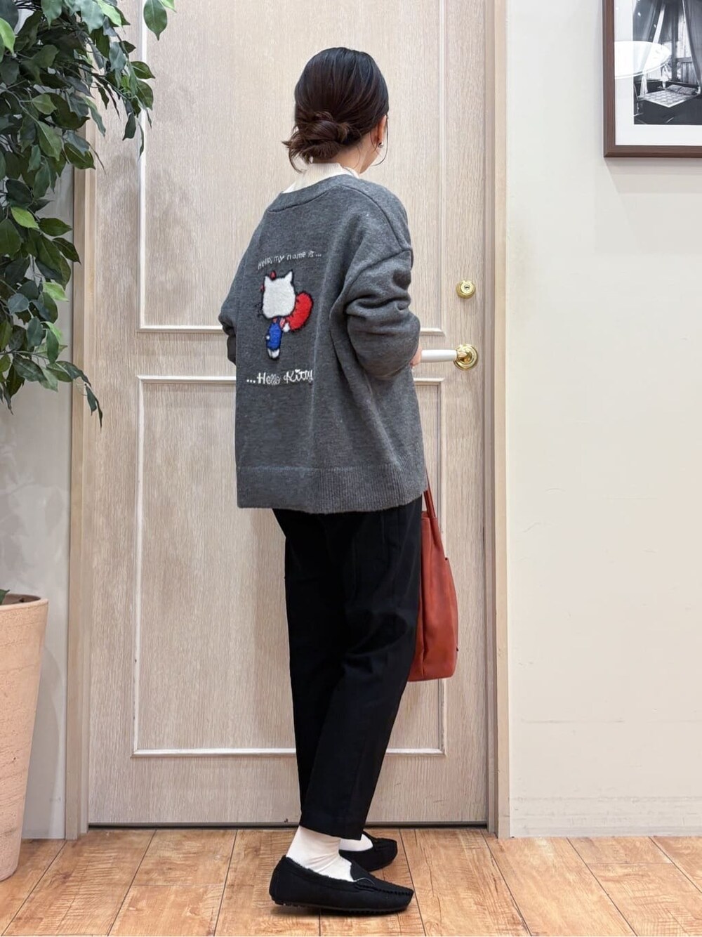 グレー系のカーディガン/ボレロ、ホワイト系のニット/セーター、ブラック系のその他パンツを着用したレディースの冬コーディネートの3枚目の写真