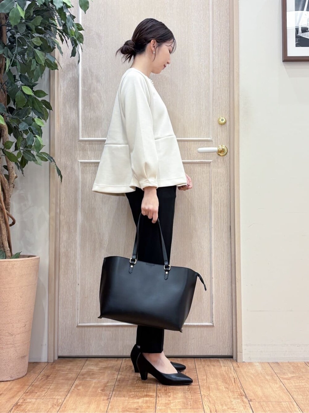 グレー系のトレンチコート、ホワイト系のTシャツ/カットソー、ブラック系のその他パンツを着用したレディースの冬コーディネートの5枚目の写真