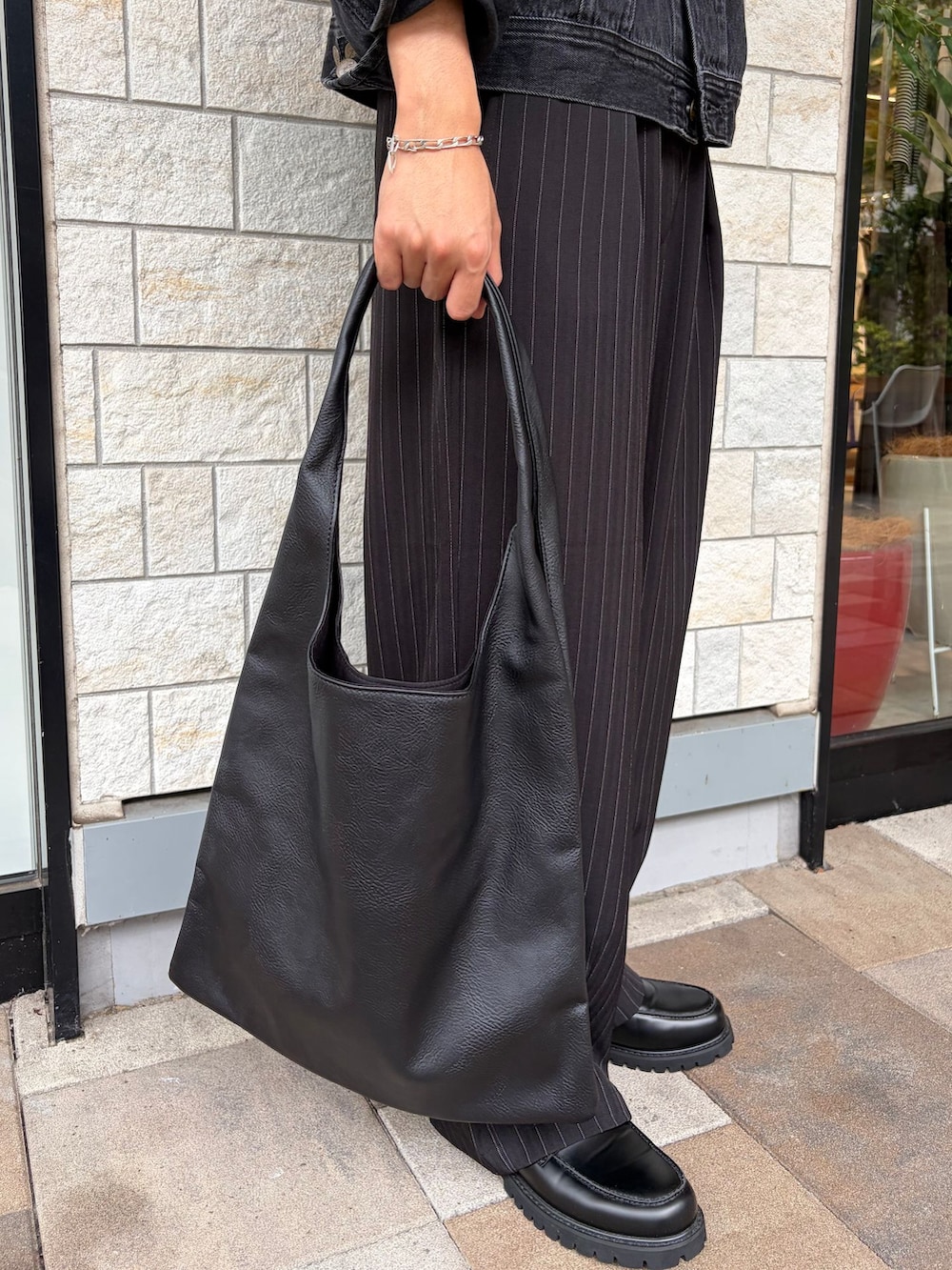 ブラック系のローファー、ブラック系のデニムジャケット、ホワイト系のTシャツ/カットソーを着用したメンズの秋コーディネートの6枚目の写真