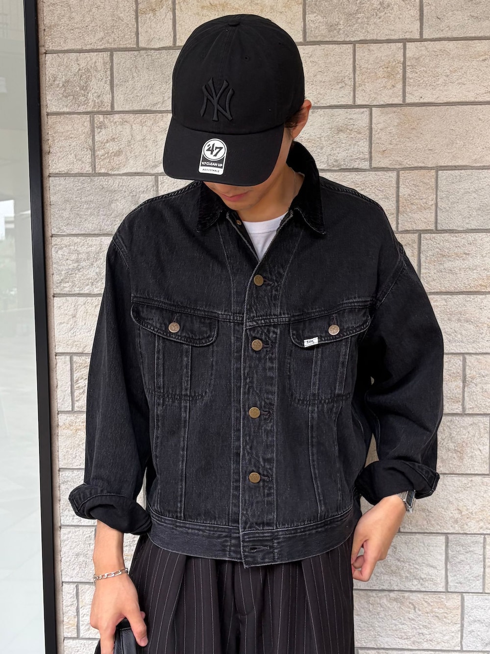 ブラック系のローファー、ブラック系のデニムジャケット、ホワイト系のTシャツ/カットソーを着用したメンズの秋コーディネートの4枚目の写真
