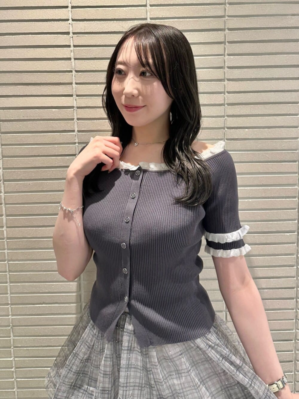 グレー系のニット/セーター、ブルー系のスカート、ホワイト系のサンダルを着用したレディースの夏コーディネートの3枚目の写真