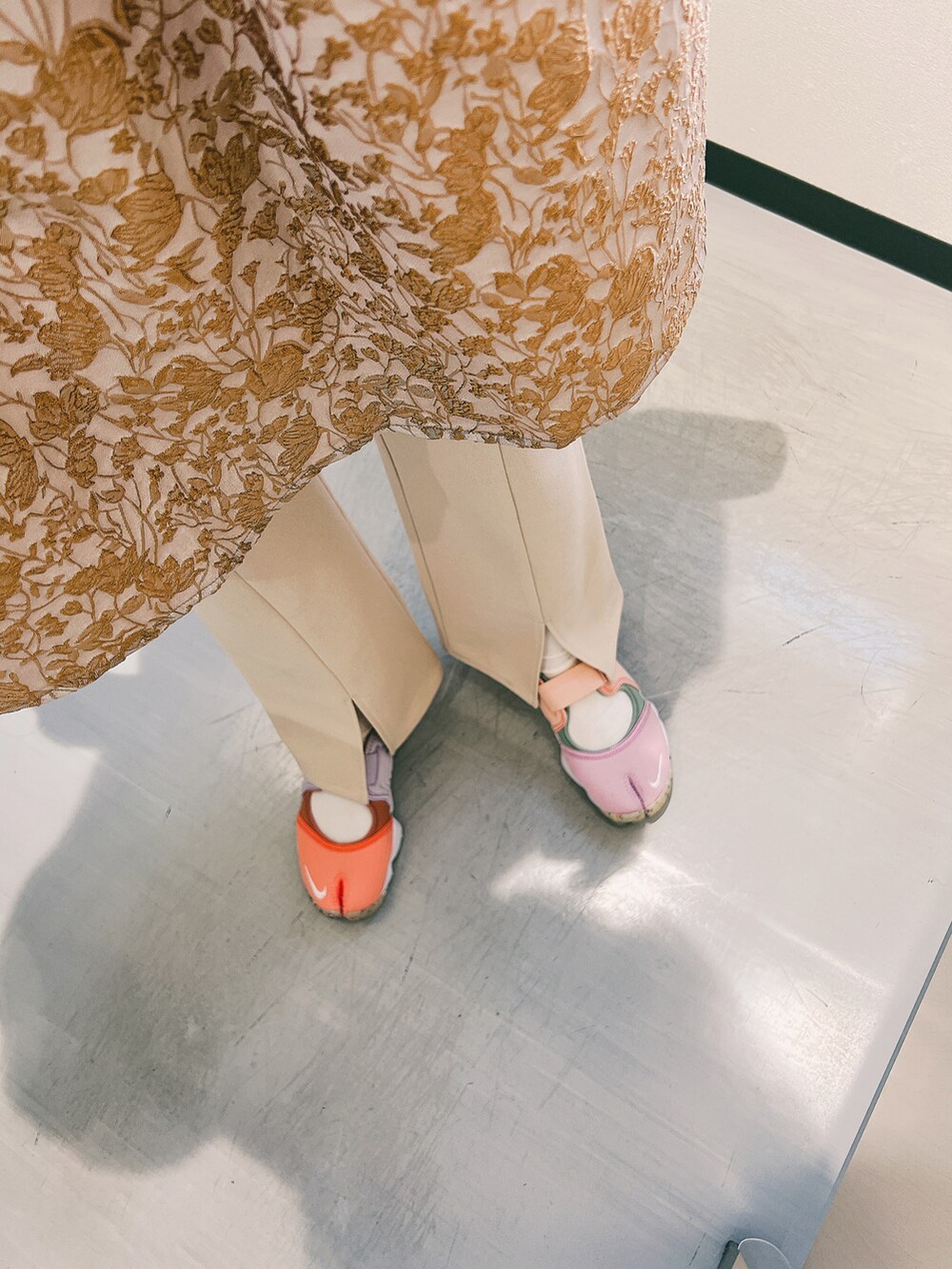 グリーン系のトップスを着用したレディースの秋コーディネートの2枚目の写真