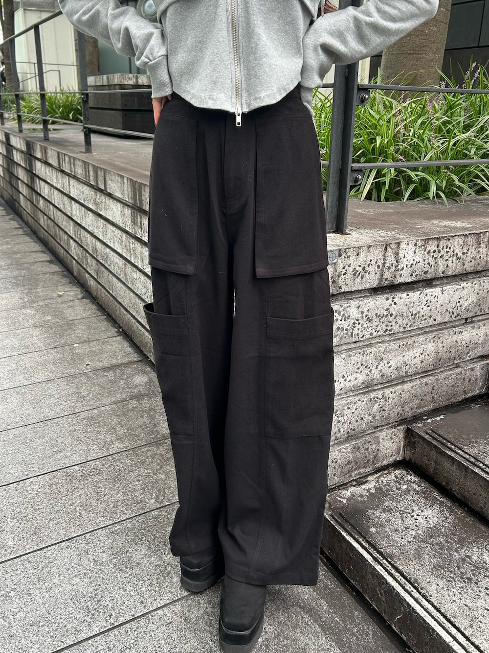 ブラック系のカーゴパンツ、グレー系のパーカー、ブラック系のブーツを着用したレディースの秋コーディネートの6枚目の写真