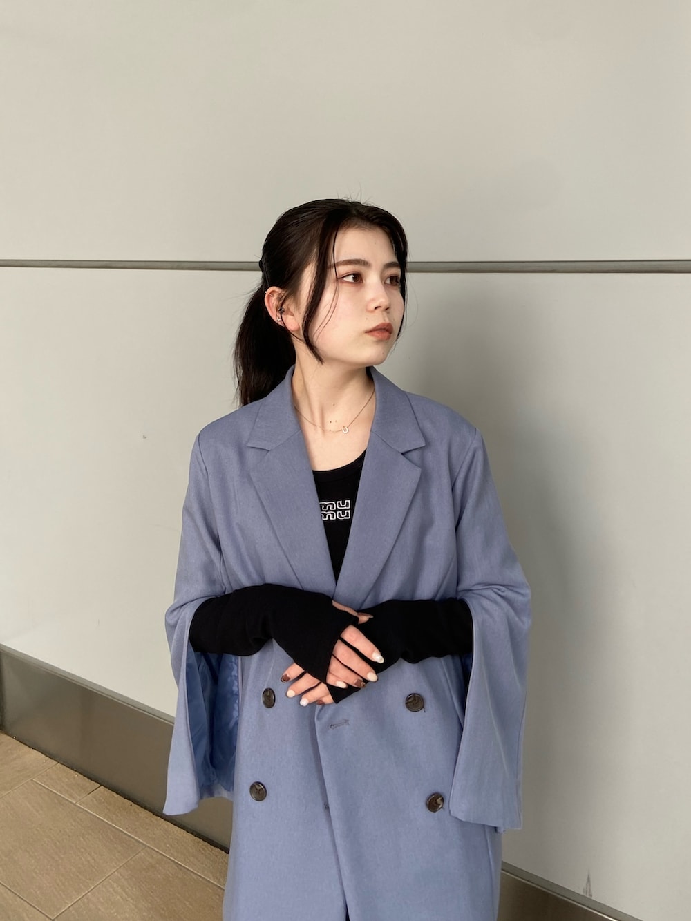 ブルー系のテーラードジャケット、ブラック系のTシャツ/カットソー、ブラック系のスカートを着用したレディースの冬コーディネートの3枚目の写真