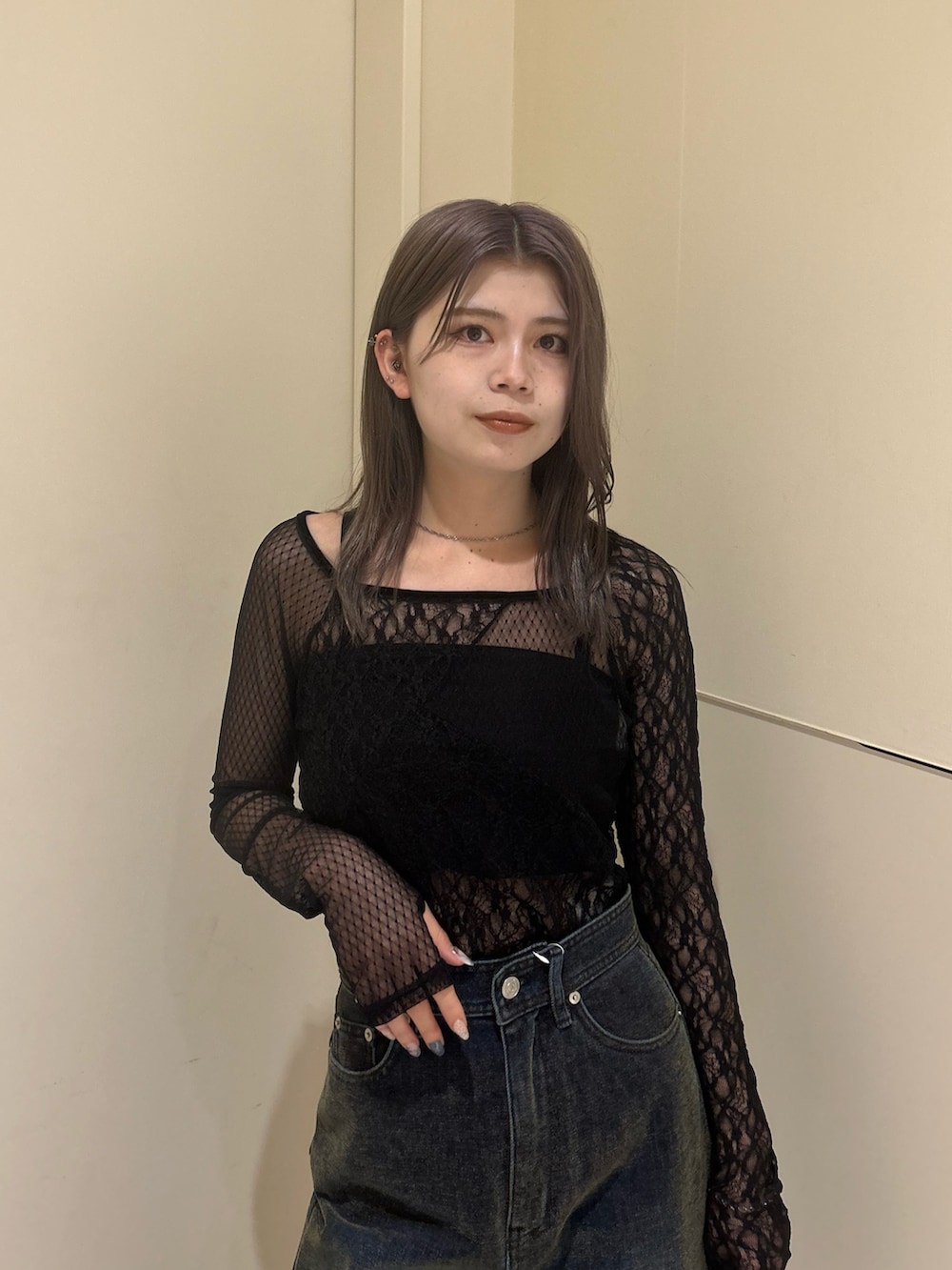 グリーン系のデニムパンツ、ブラック系のTシャツ/カットソー、ブラック系のブーツを着用したレディースの秋コーディネートの4枚目の写真