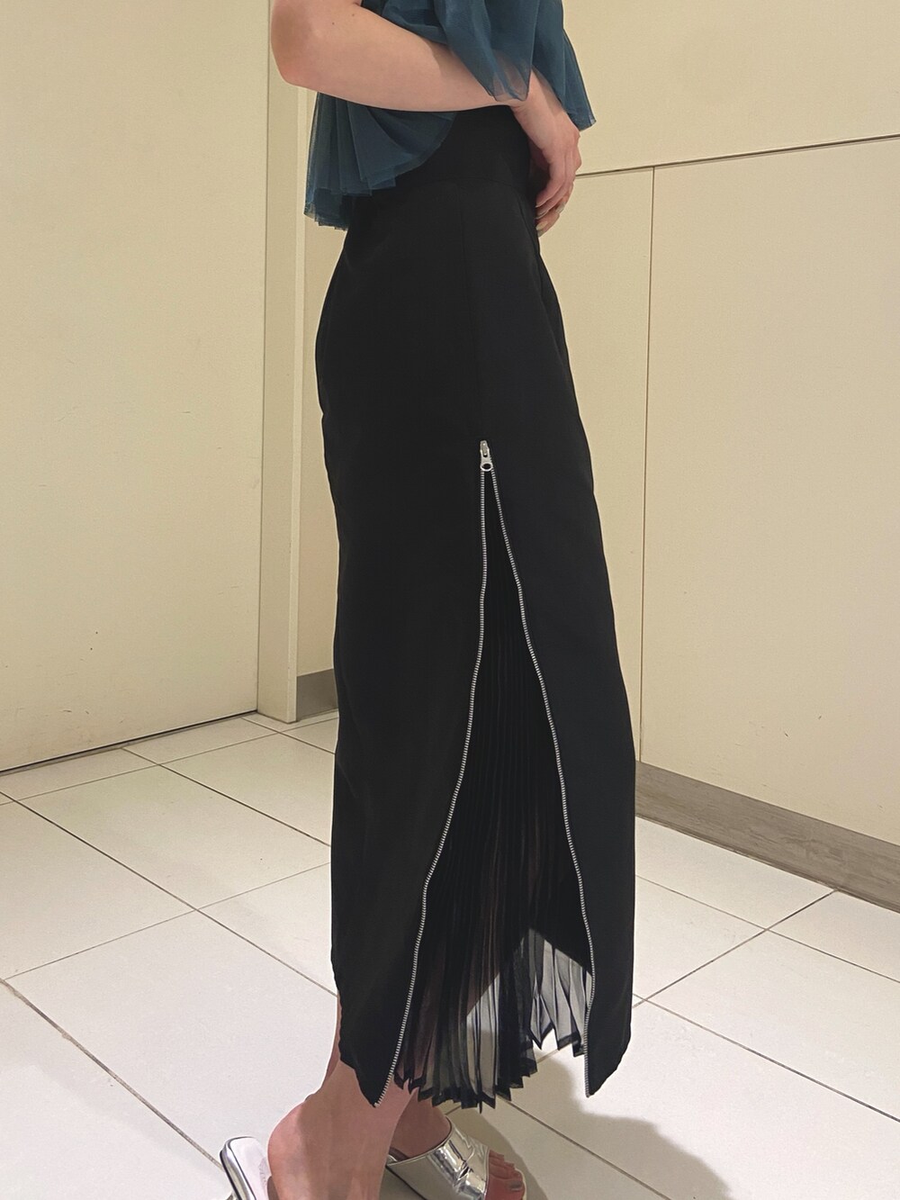 ブラック系のスカート、ブラック系のTシャツ/カットソー、シルバー系のサンダルを着用したレディースの夏コーディネートの5枚目の写真