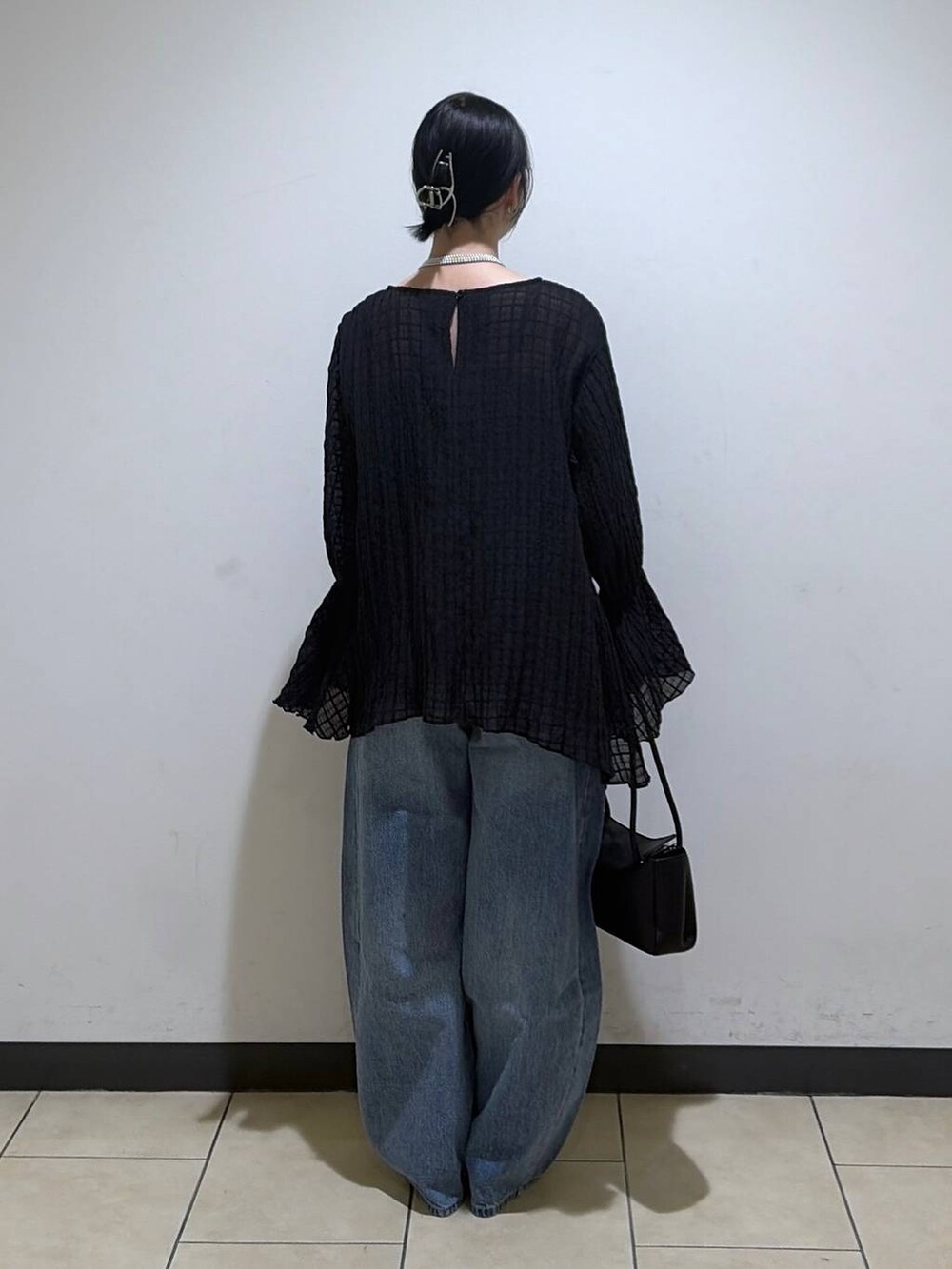 ブルー系のデニムパンツを着用したレディースの春コーディネートの3枚目の写真