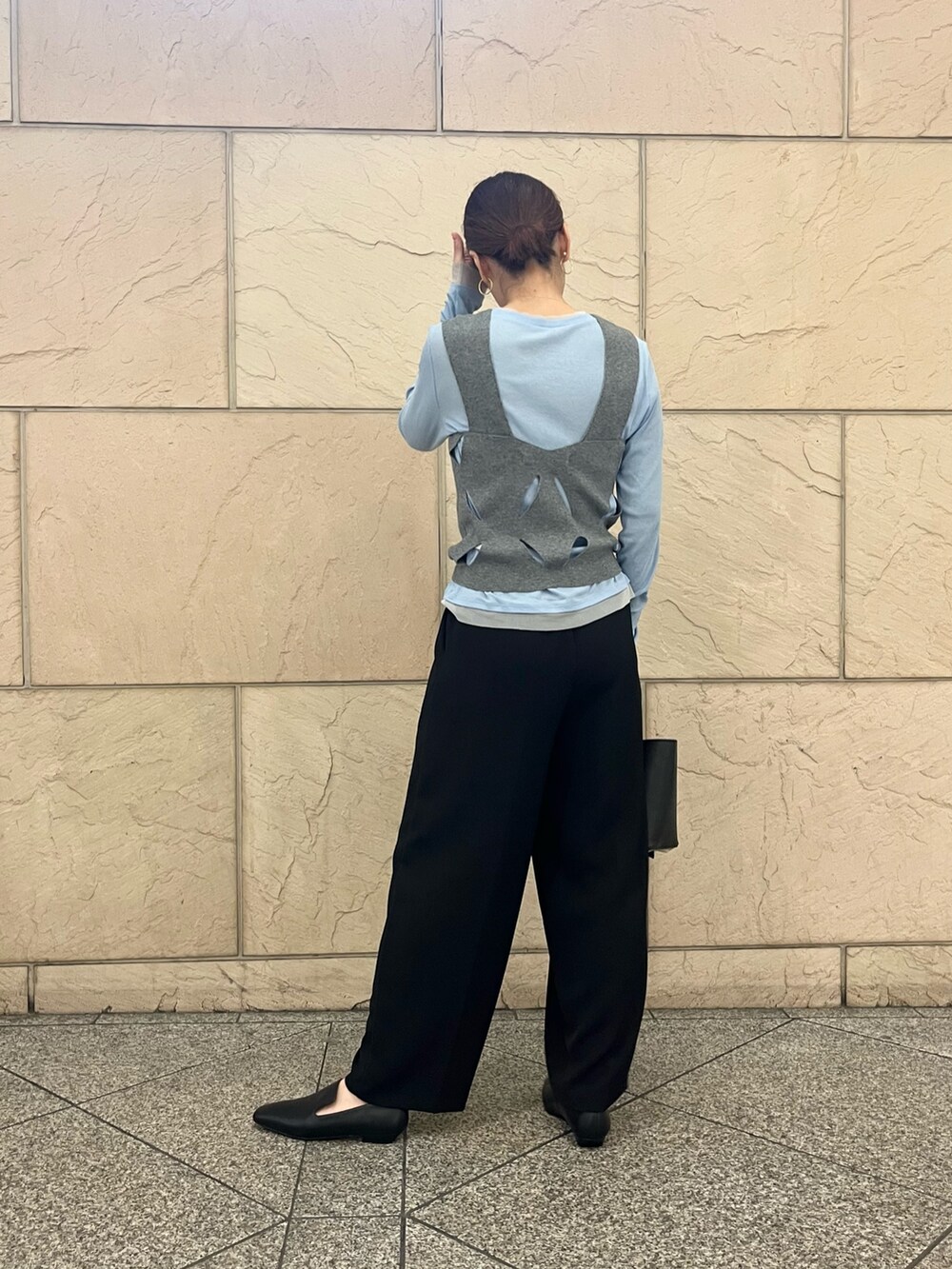 ブラック系のローファー、ブラック系のハンドバッグ、ホワイト系のニット/セーターを着用したレディースの秋コーディネートの2枚目の写真