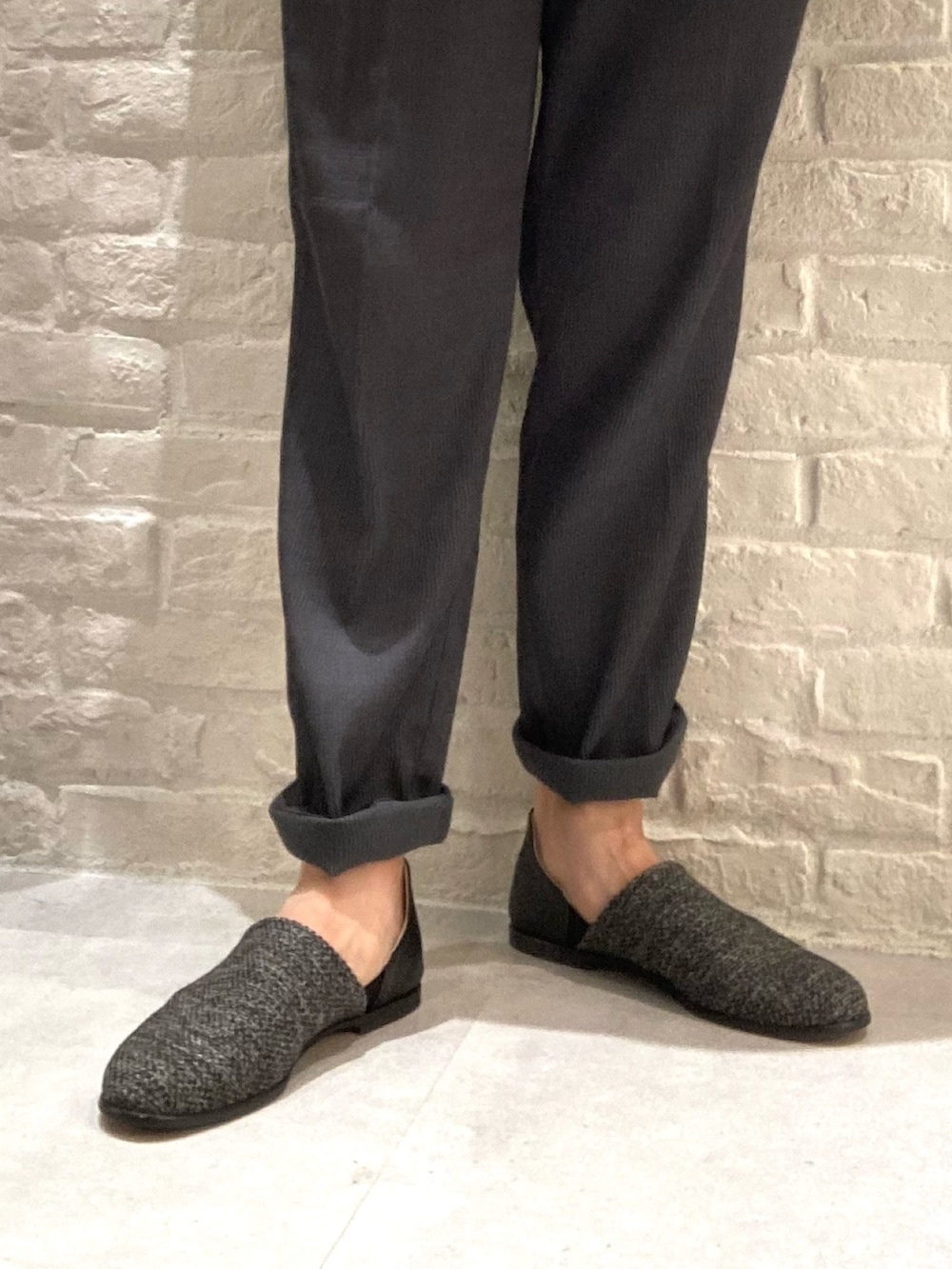 ブラック系のスリッポン、ブラック系のシャツ/ブラウス、グレー系のスラックスを着用したメンズの秋コーディネートの2枚目の写真