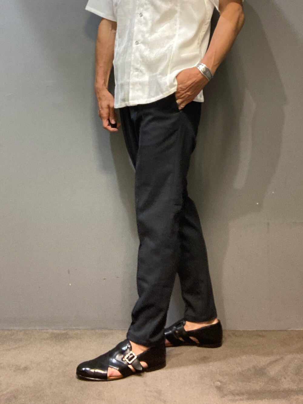 ブラック系のサンダル、ブルー系のその他パンツ、ホワイト系のTシャツ/カットソーを着用したメンズの春コーディネートの2枚目の写真