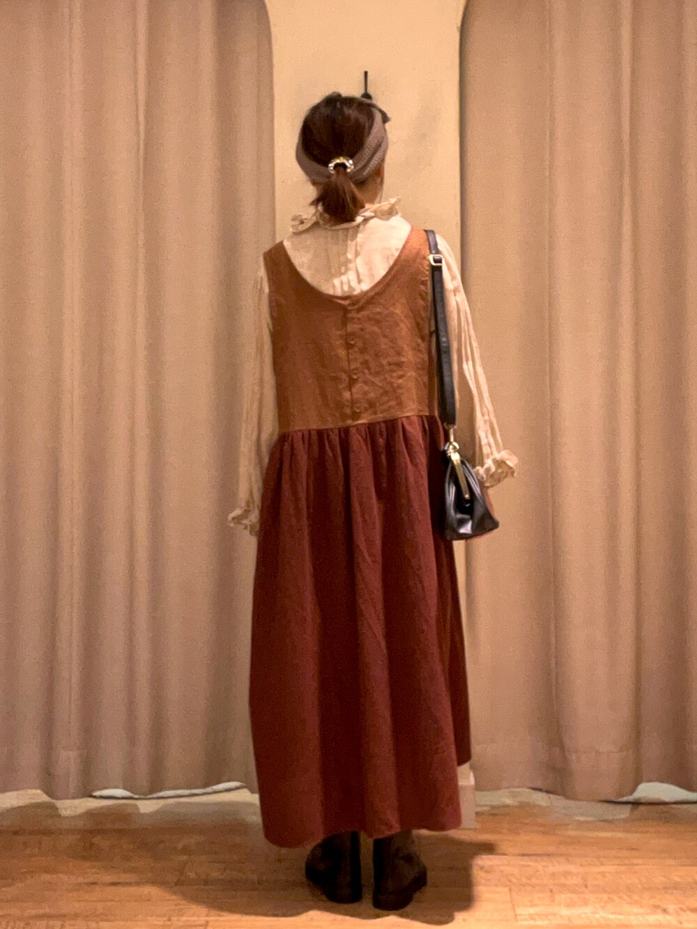 ブラウン系のワンピース、グリーン系のシャツ/ブラウス、ブラック系のハンドバッグを着用したレディースの秋コーディネートの3枚目の写真