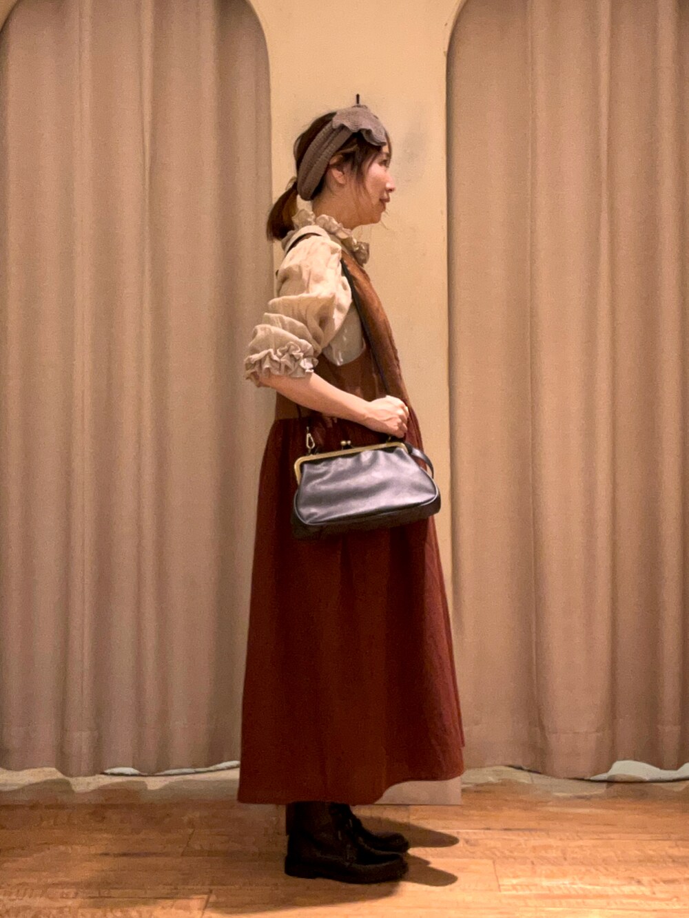 ブラウン系のワンピース、グリーン系のシャツ/ブラウス、ブラック系のハンドバッグを着用したレディースの秋コーディネートの2枚目の写真