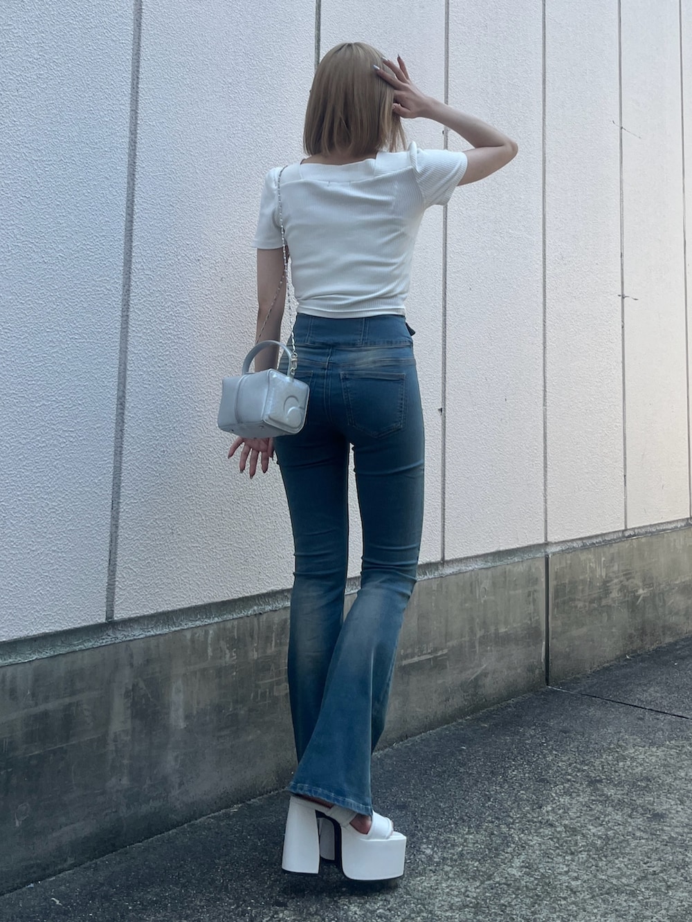 ホワイト系のTシャツ/カットソー、ブルー系のデニムパンツ、シルバー系のハンドバッグを着用したレディースの夏コーディネートの3枚目の写真