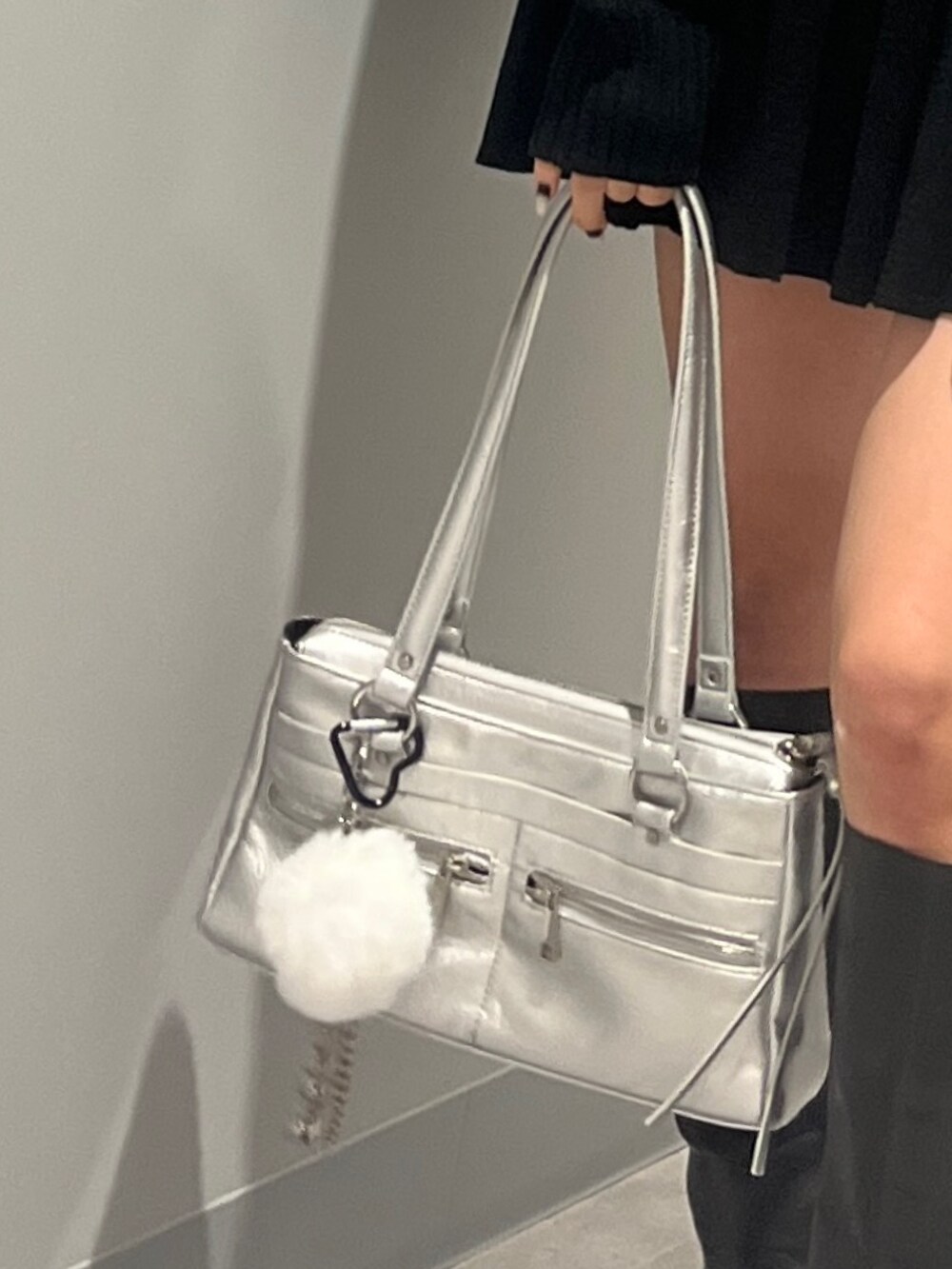 ブラック系のニット/セーター、ブラック系のスカート、ブラック系のブーツを着用したレディースの秋コーディネートの7枚目の写真