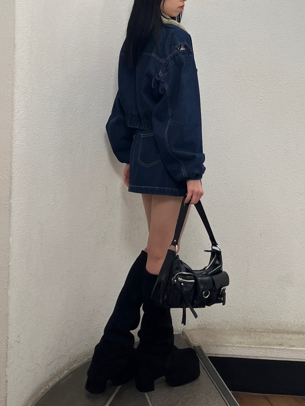 ブルー系のスカート、ブルー系のブルゾン、ホワイト系のTシャツ/カットソーを着用したレディースの秋コーディネートの2枚目の写真