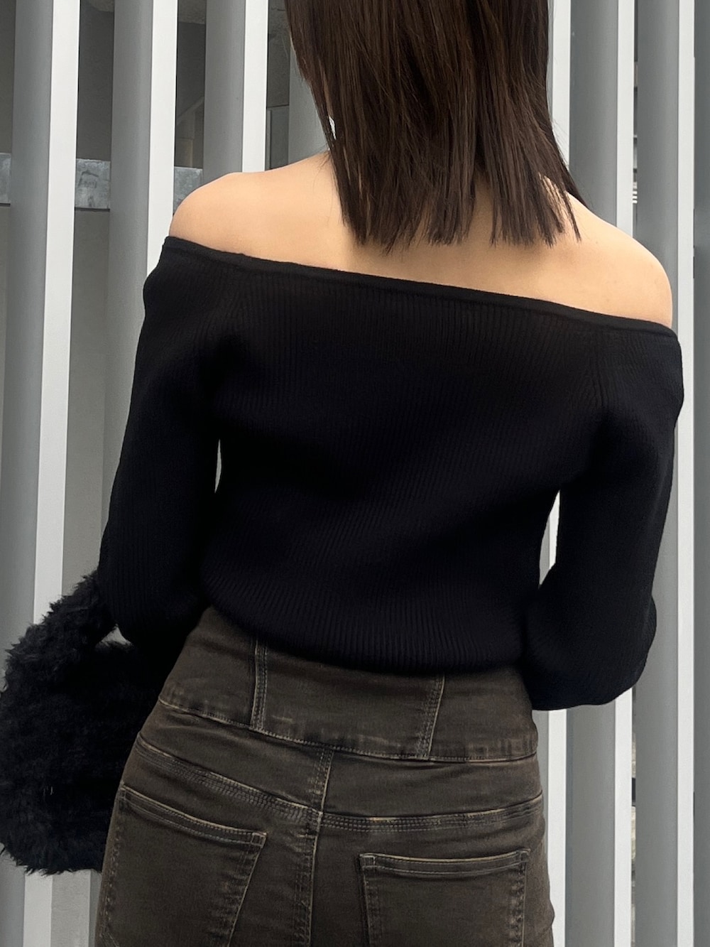 ブラック系のデニムパンツ、ブラウン系のブルゾン、ブラック系のハンドバッグを着用したレディースの秋コーディネートの6枚目の写真