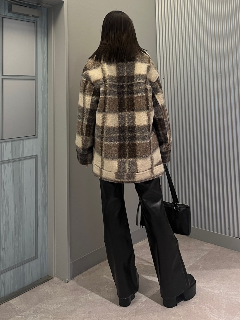 ブラック系のその他パンツ、シルバー系のブーツ、ブラック系のショルダーバッグを着用したレディースの秋コーディネートの3枚目の写真