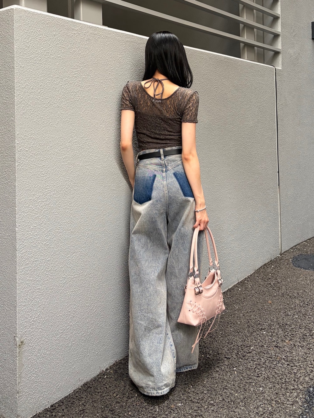ピンク系のショルダーバッグ、ブルー系のデニムパンツ、グレー系のTシャツ/カットソーを着用したレディースの夏コーディネートの3枚目の写真