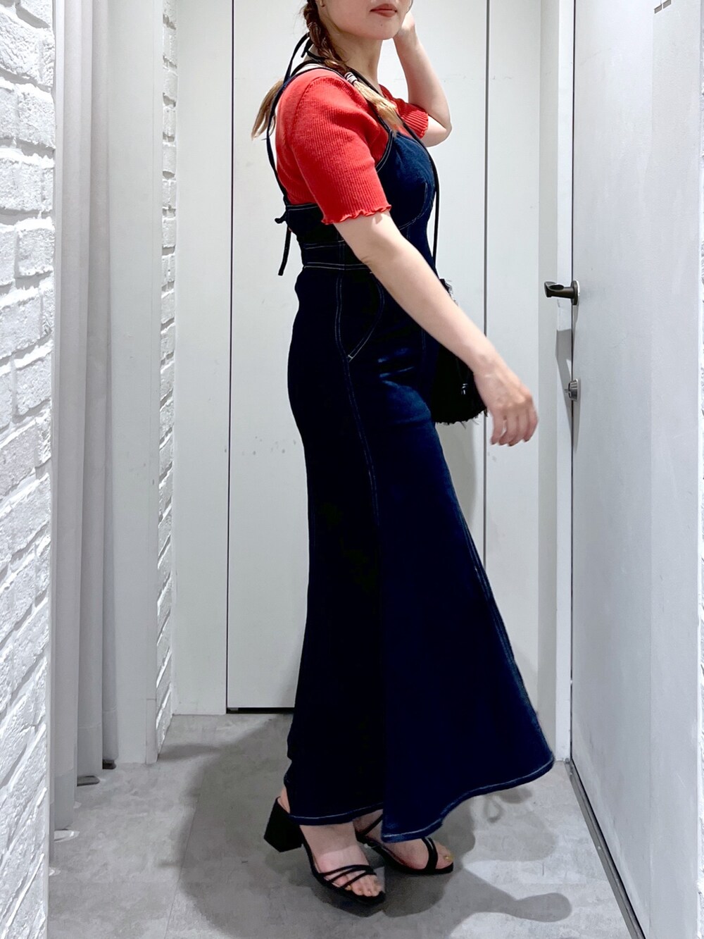 ブラック系のハンドバッグ、ブルー系のワンピース、レッド系のニット/セーターを着用したレディースの夏コーディネートの5枚目の写真