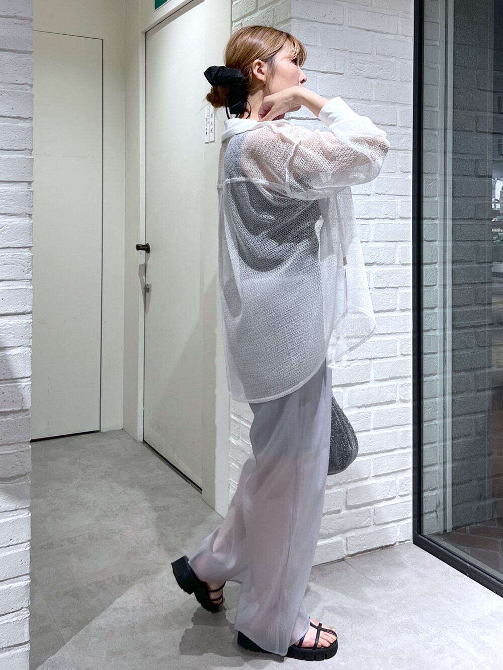 ホワイト系のシャツ/ブラウス、グレー系のその他パンツ、ブラック系のサンダルを着用したレディースの夏コーディネートの3枚目の写真