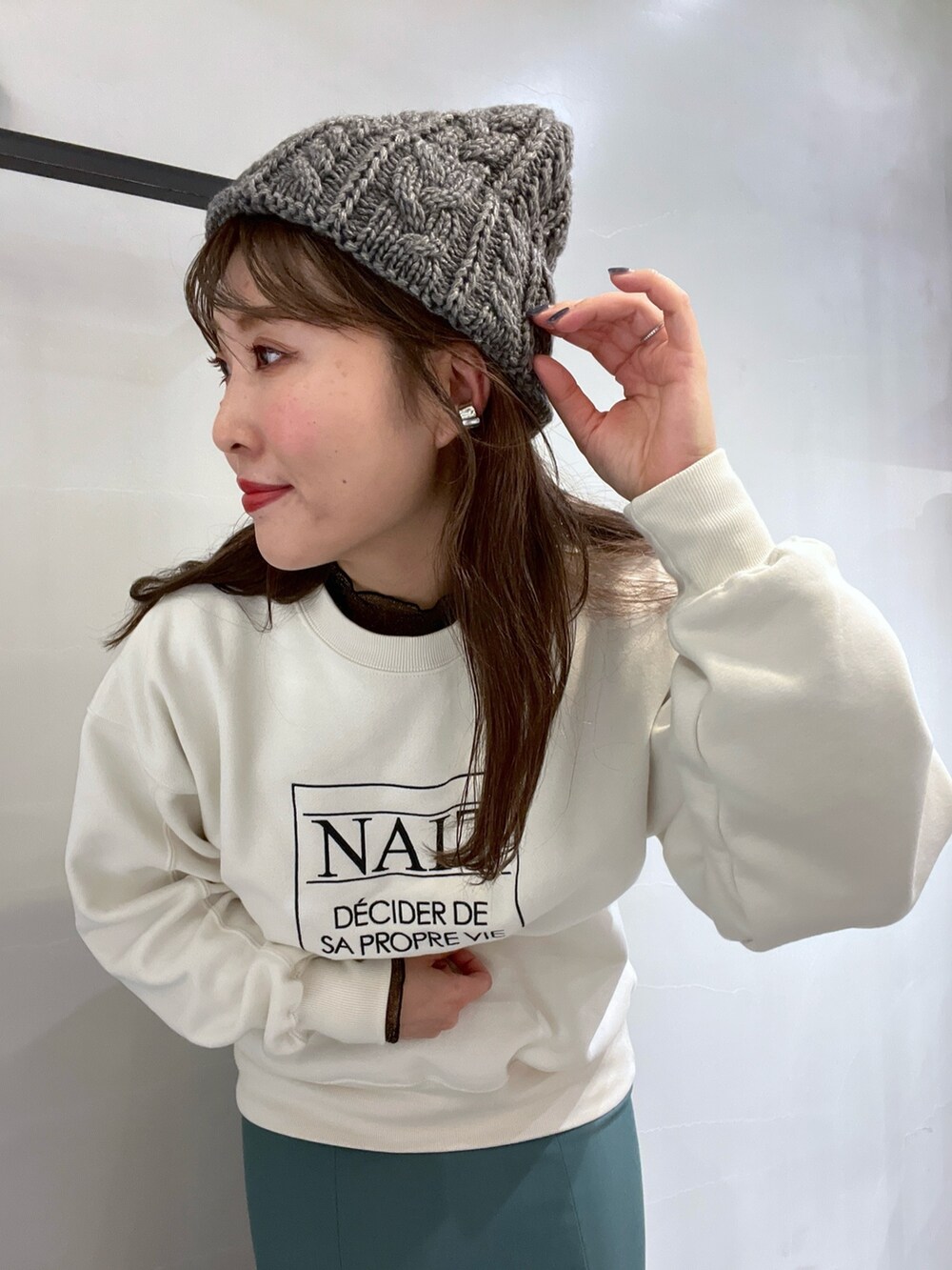 ブラック系のハンドバッグ、ブラック系のTシャツ/カットソー、ホワイト系のスウェットを着用したレディースの冬コーディネートの6枚目の写真