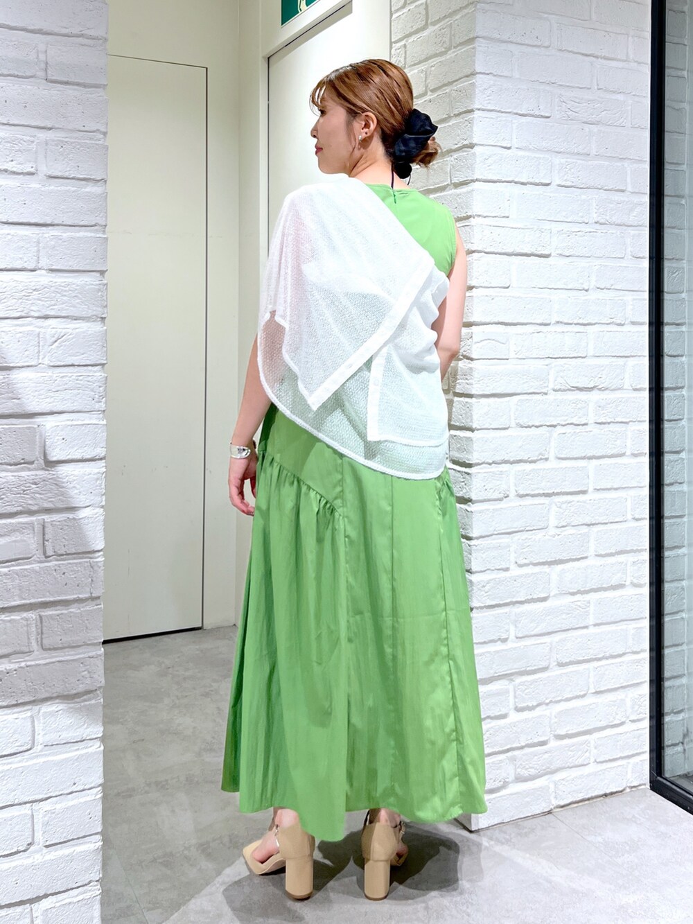 グリーン系のワンピース、ホワイト系のシャツ/ブラウス、ブラック系のハンドバッグを着用したレディースの夏コーディネートの3枚目の写真