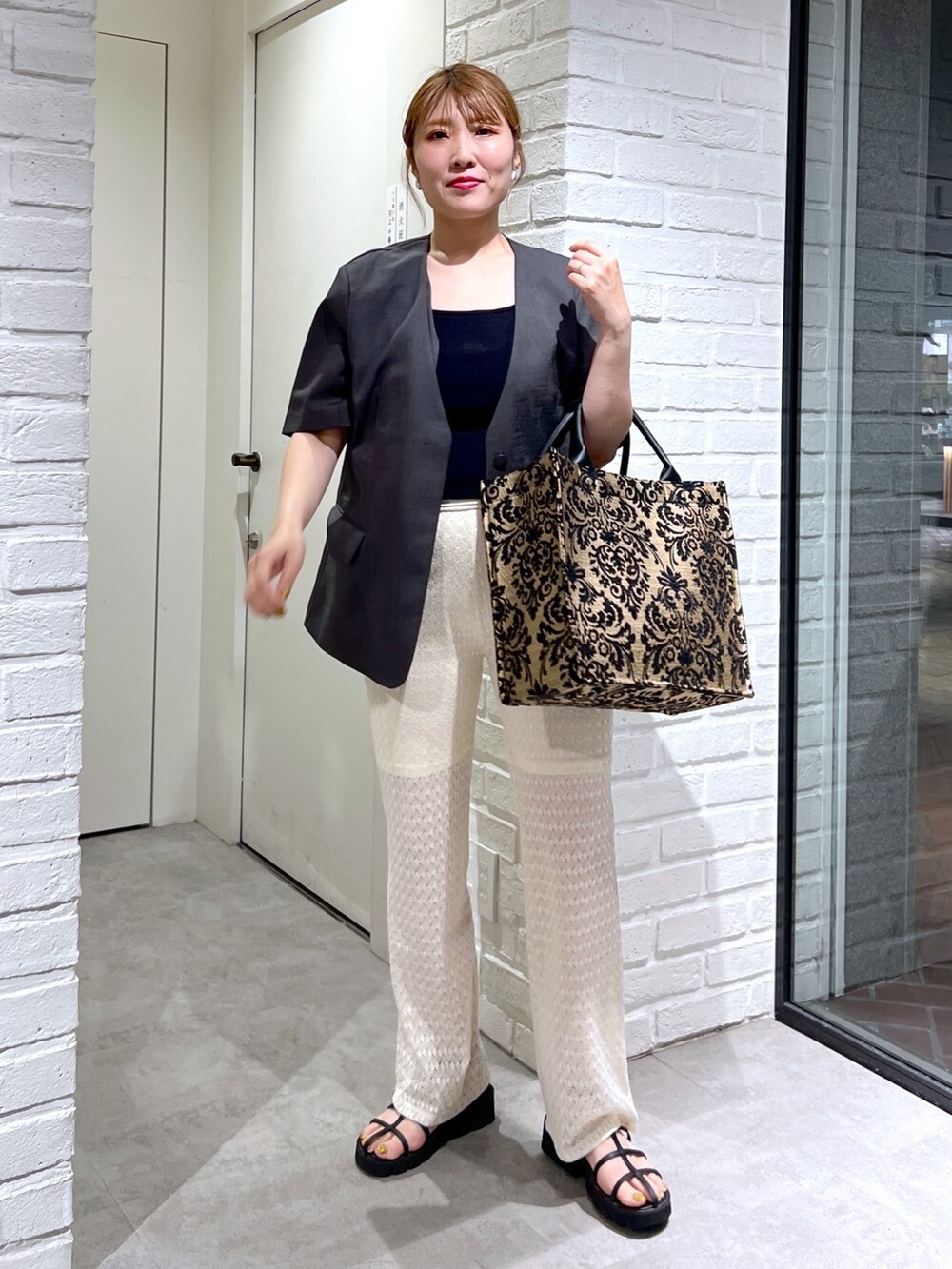 ホワイト系のその他パンツ、グレー系のノーカラージャケット、ブラック系のタンクトップを着用したレディースの夏コーディネートの2枚目の写真