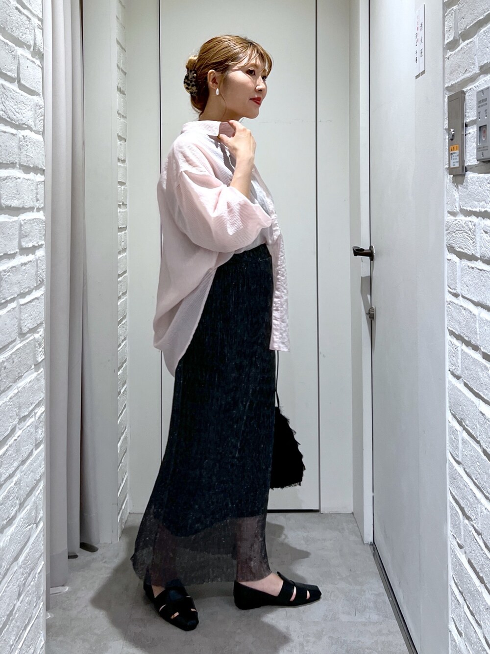 ブラック系のスカート、ピンク系のシャツ/ブラウス、ブラック系のタンクトップを着用したレディースの夏コーディネートの3枚目の写真