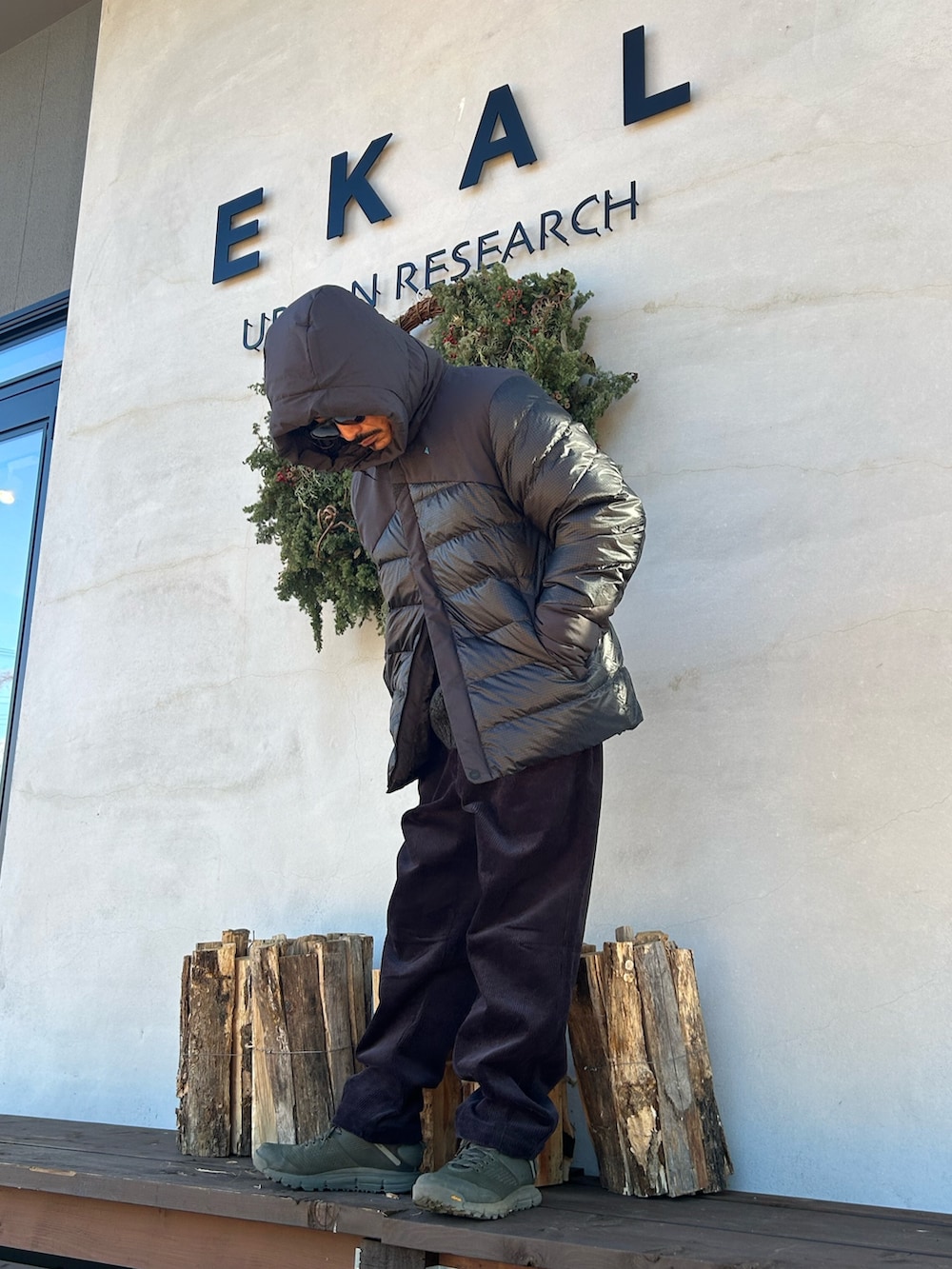 ブラック系のその他アウター、グレー系のニット/セーター、グレー系のその他パンツを着用したメンズの冬コーディネートの2枚目の写真