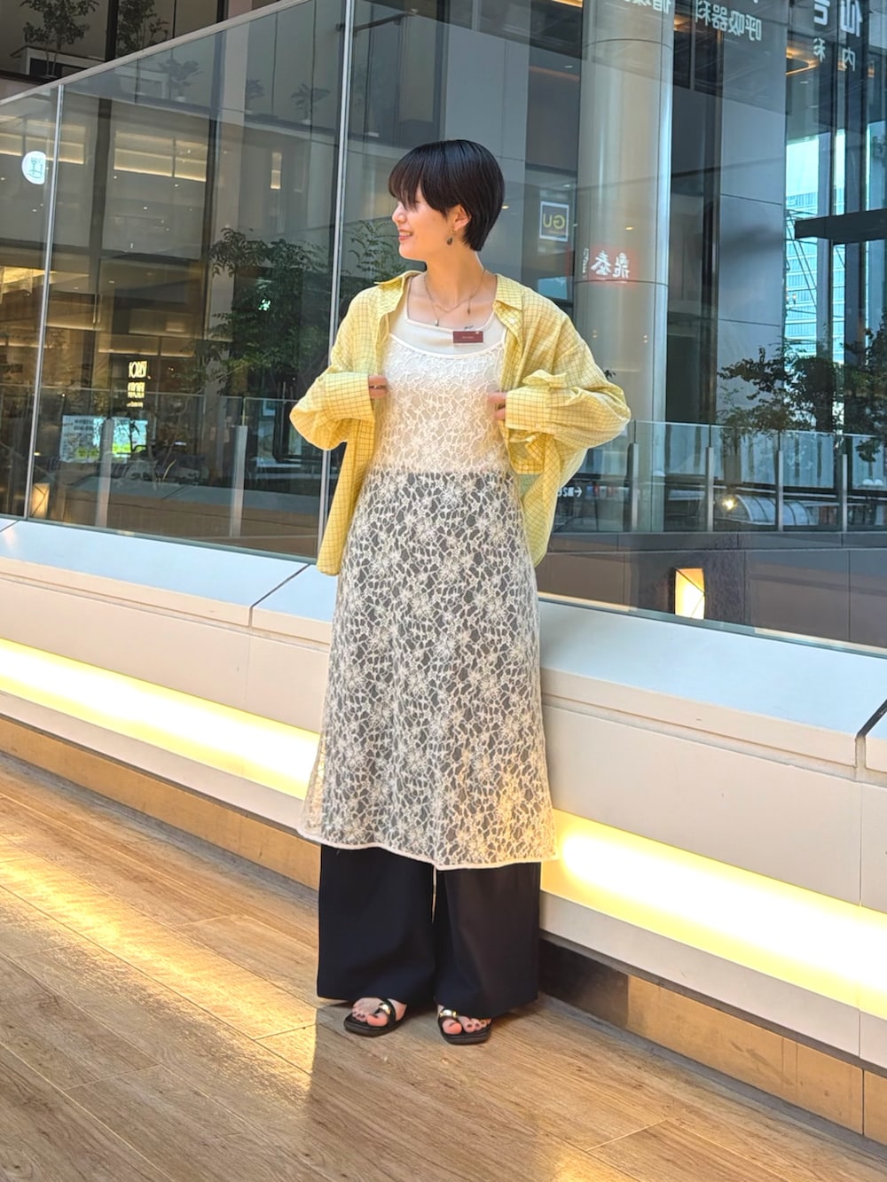 ブラック系のサンダル、ブルー系のその他パンツ、ホワイト系のワンピースを着用したレディースの夏コーディネートの6枚目の写真
