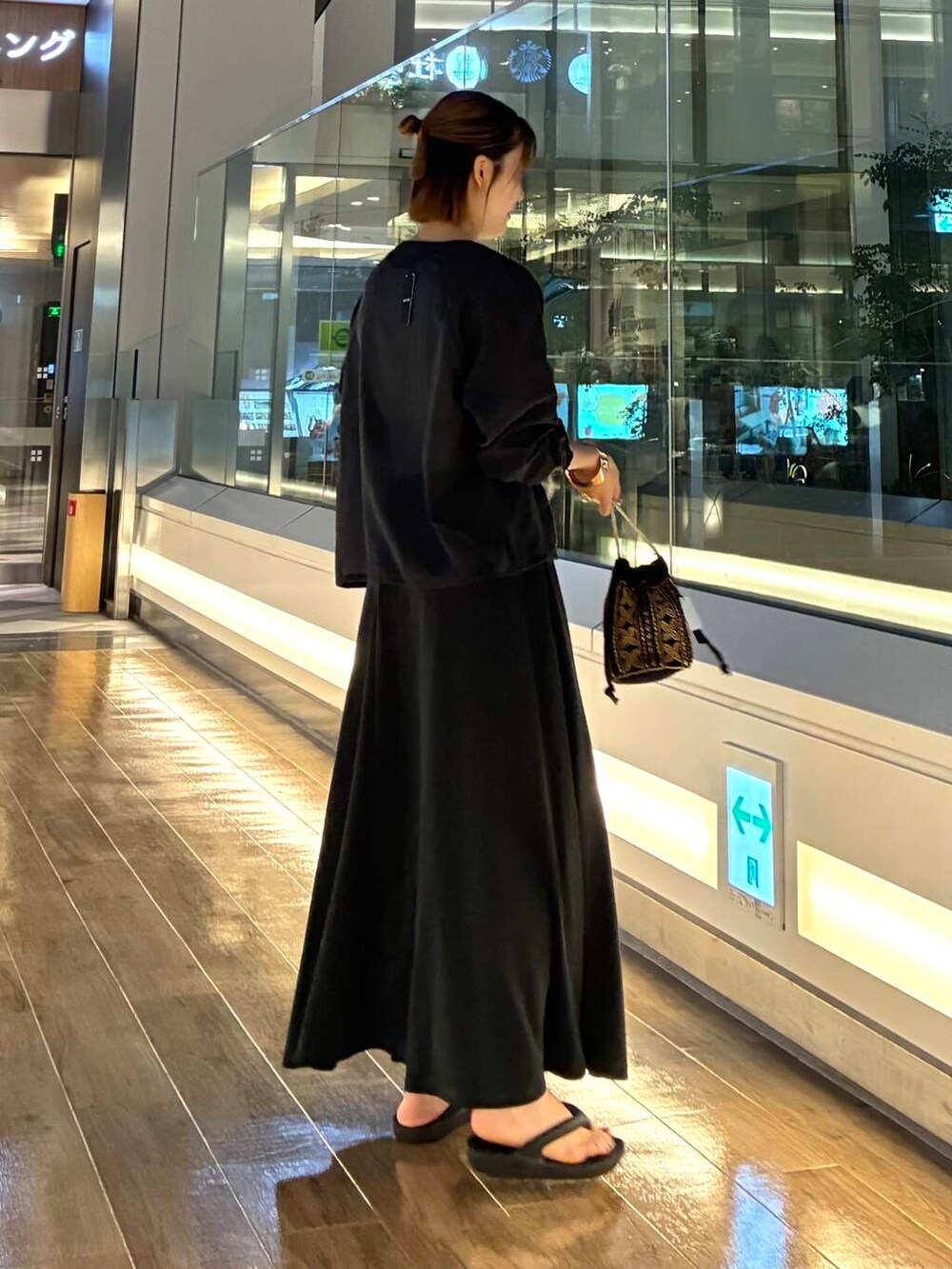 ブラック系のショルダーバッグ、ブラック系のスカート、ブラック系のカーディガン/ボレロを着用したレディースの夏コーディネートの3枚目の写真