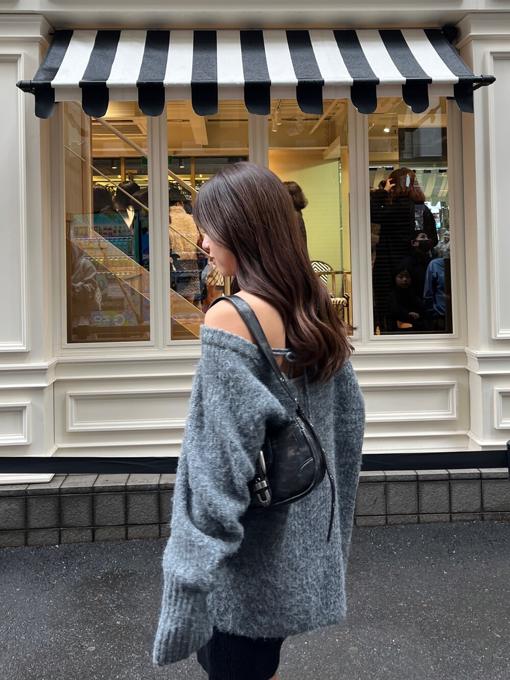 グレー系のニット/セーター、ブラック系のその他パンツを着用したレディースの秋コーディネートの3枚目の写真