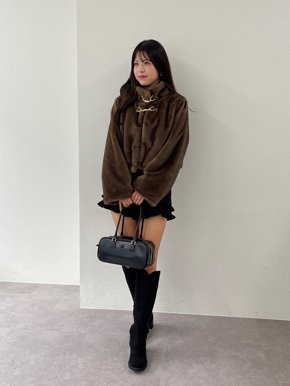 ブラウン系のブルゾン、ブラック系のブーツ、ブラック系のその他パンツを着用したレディースの秋コーディネートの4枚目の写真