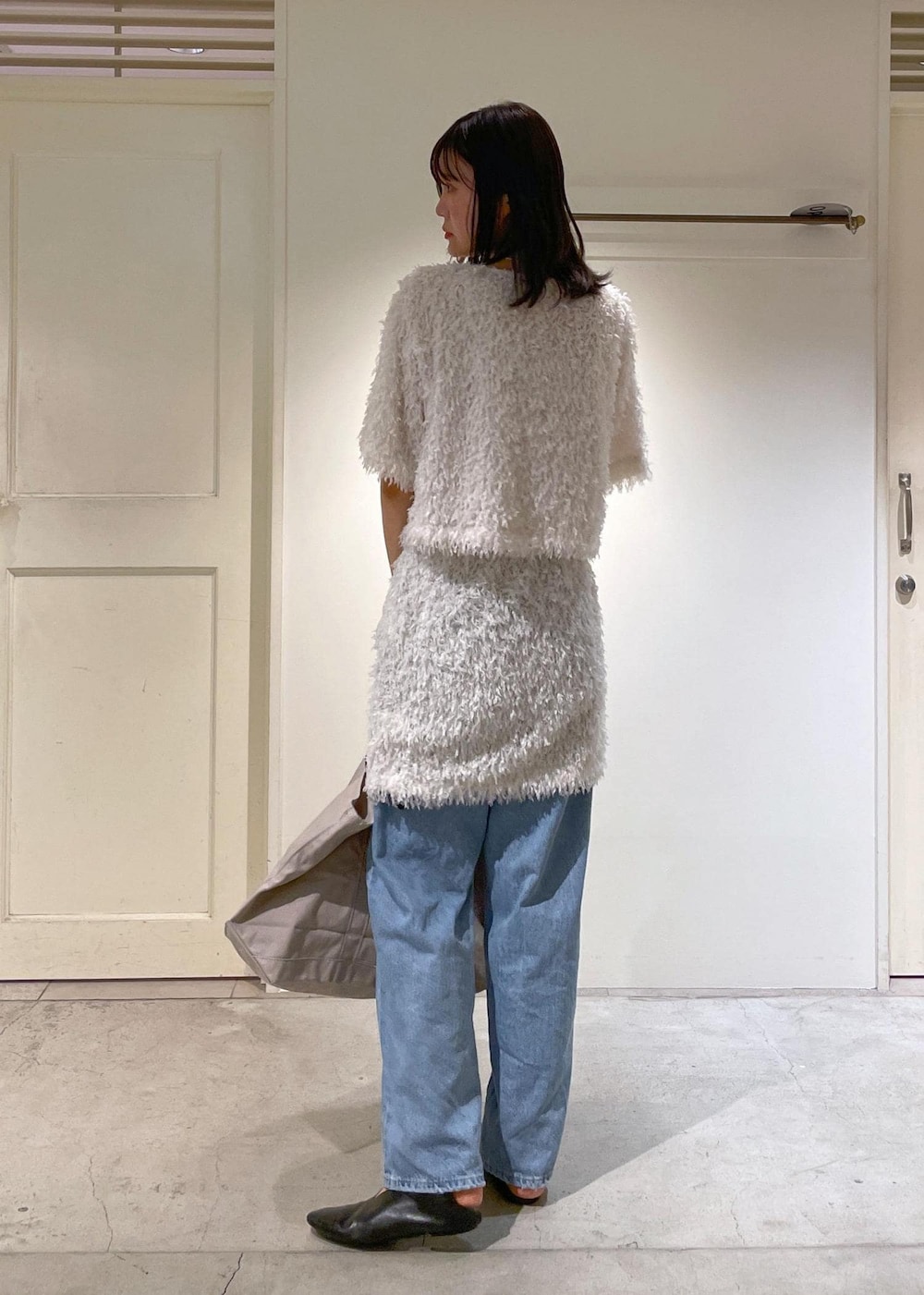 ブルー系のデニムパンツ、ホワイト系のスカート、ホワイト系のTシャツ/カットソーを着用したレディースの夏コーディネートの3枚目の写真