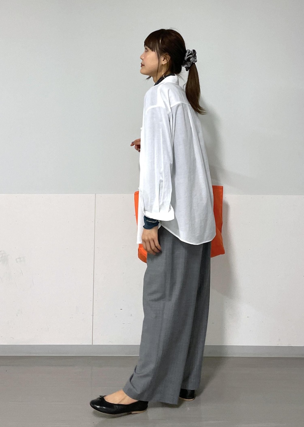 ブルー系のTシャツ/カットソー、グレー系のスラックス、ホワイト系のシャツ/ブラウスを着用したレディースの夏コーディネートの4枚目の写真