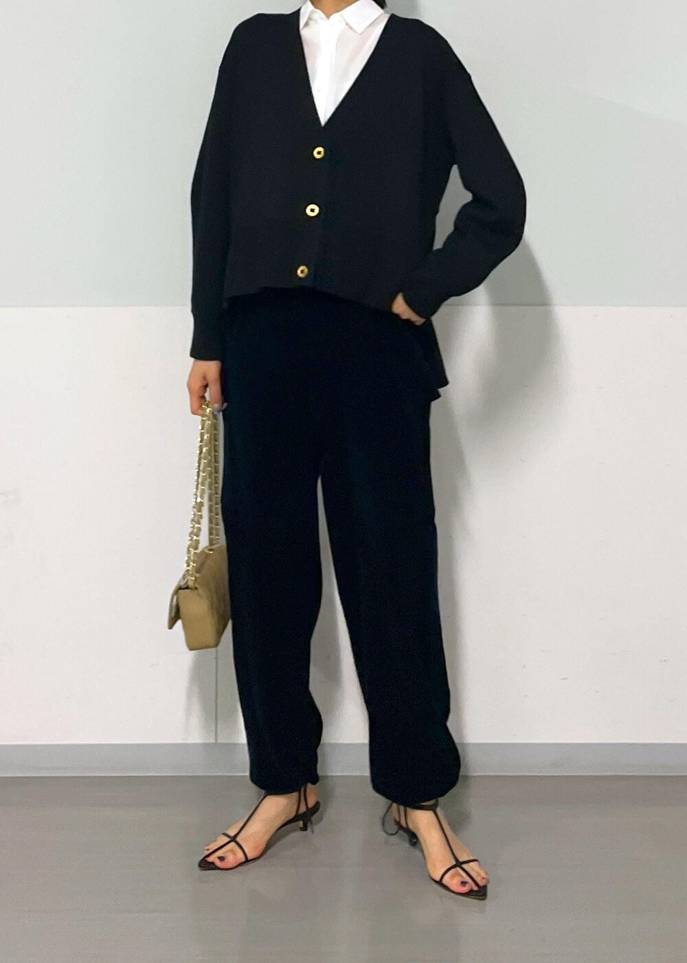 ベージュ系のショルダーバッグ、ブラック系のサンダル、ブラック系のカーゴパンツを着用したレディースの秋コーディネートの6枚目の写真