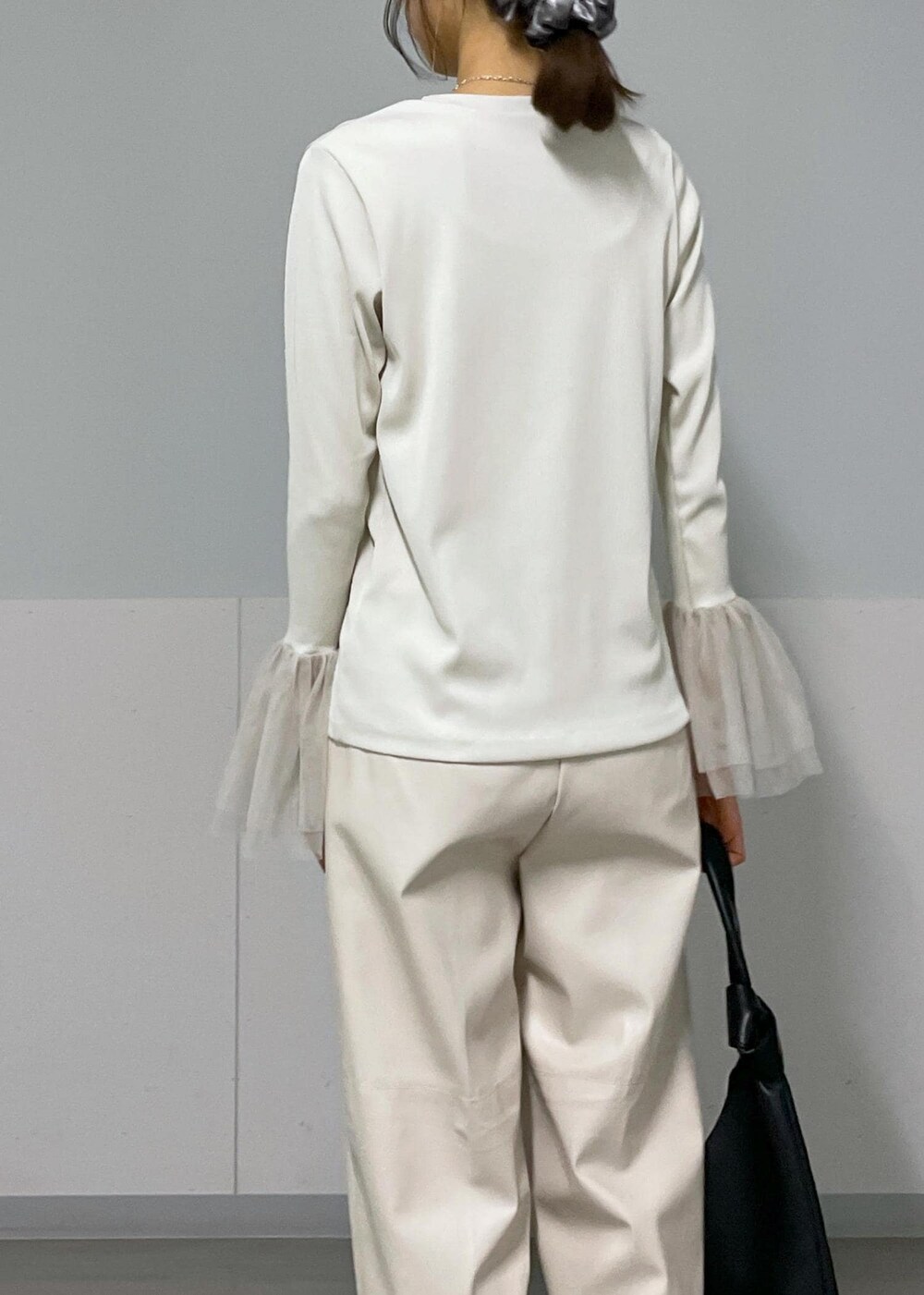 ベージュ系のジャンパースカート、ホワイト系のTシャツ/カットソー、ブラック系のバレエシューズを着用したレディースの秋コーディネートの8枚目の写真