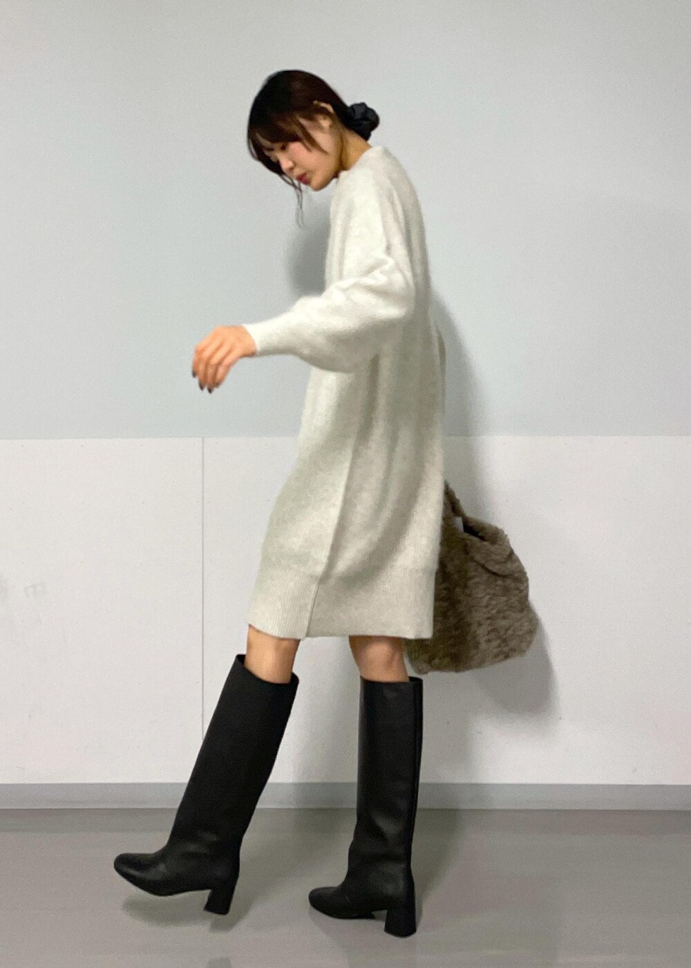 ホワイト系のワンピース、ブラック系のブーツ、ブラック系のTシャツ/カットソーを着用したレディースの秋コーディネートの6枚目の写真