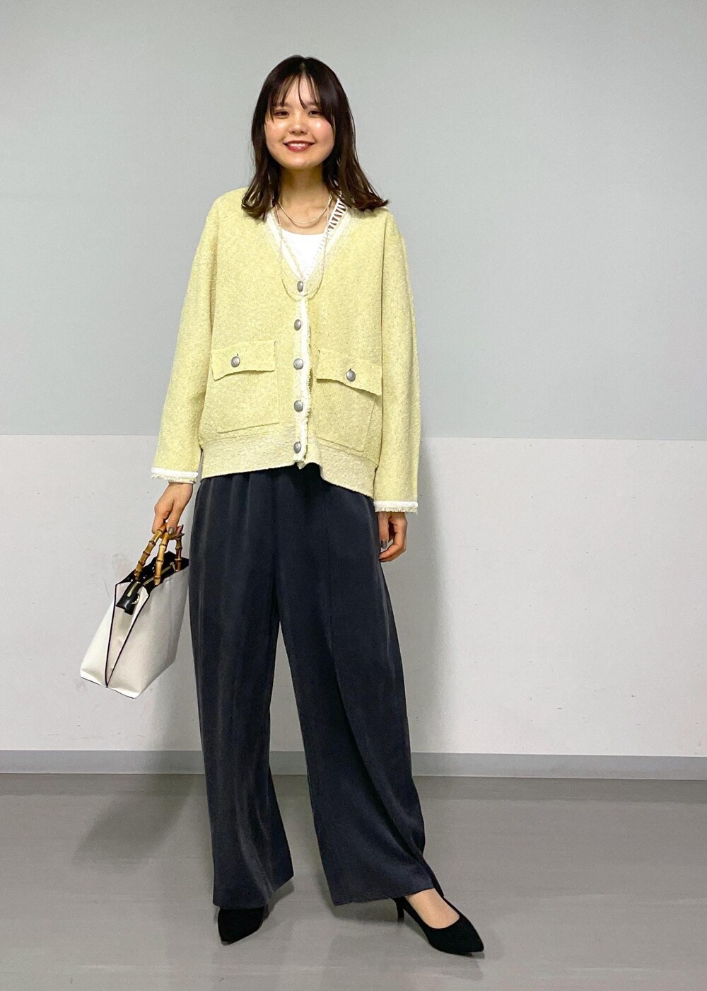 イエロー系のカーディガン/ボレロ、ホワイト系のTシャツ/カットソー、グレー系のその他パンツを着用したレディースの春コーディネートの9枚目の写真