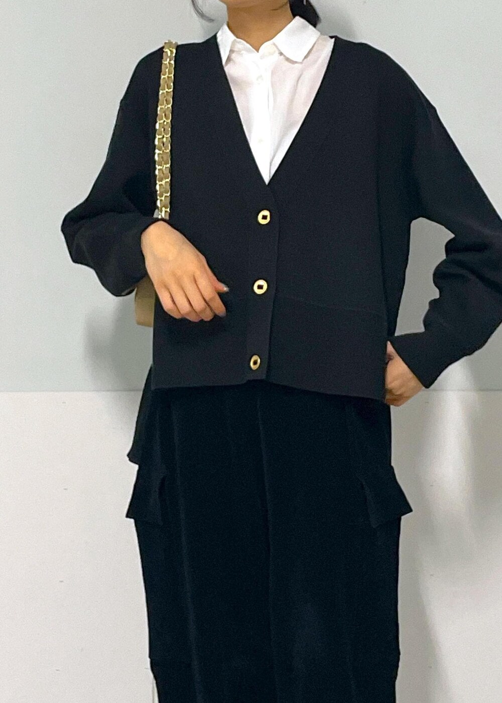 ベージュ系のショルダーバッグ、ブラック系のサンダル、ブラック系のカーゴパンツを着用したレディースの秋コーディネートの9枚目の写真