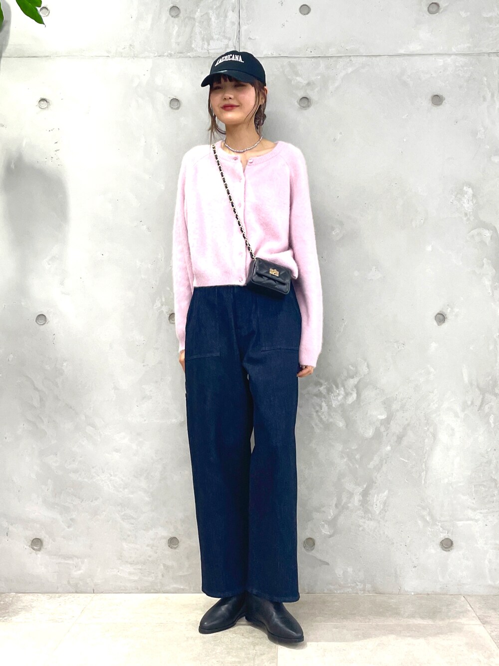 ピンク系のカーディガン/ボレロ、ブルー系のデニムパンツ、ブラック系のブーツを着用したレディースの秋コーディネートの5枚目の写真