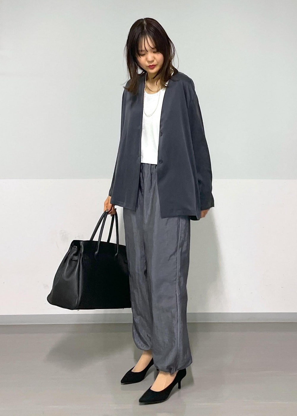 ホワイト系のTシャツ/カットソー、グレー系のその他パンツ、グレー系のノーカラージャケットを着用したレディースの冬コーディネートの10枚目の写真