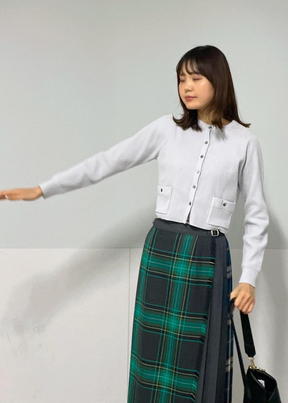 グリーン系のスカート、ホワイト系のその他シューズ、グレー系のカーディガン/ボレロを着用したレディースの冬コーディネートの9枚目の写真