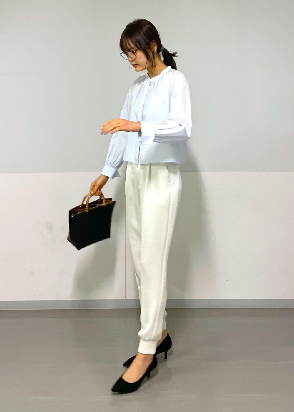 ホワイト系のその他パンツ、ブルー系のシャツ/ブラウス、ブラック系のハンドバッグを着用したレディースの冬コーディネートの8枚目の写真
