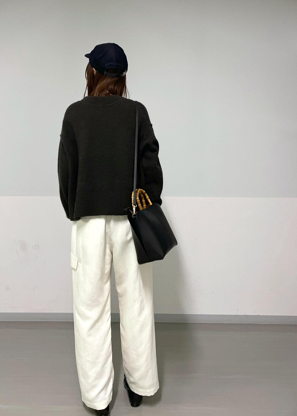 ブラウン系のニット/セーター、ホワイト系のカーゴパンツ、ホワイト系のTシャツ/カットソーを着用したレディースの冬コーディネートの9枚目の写真